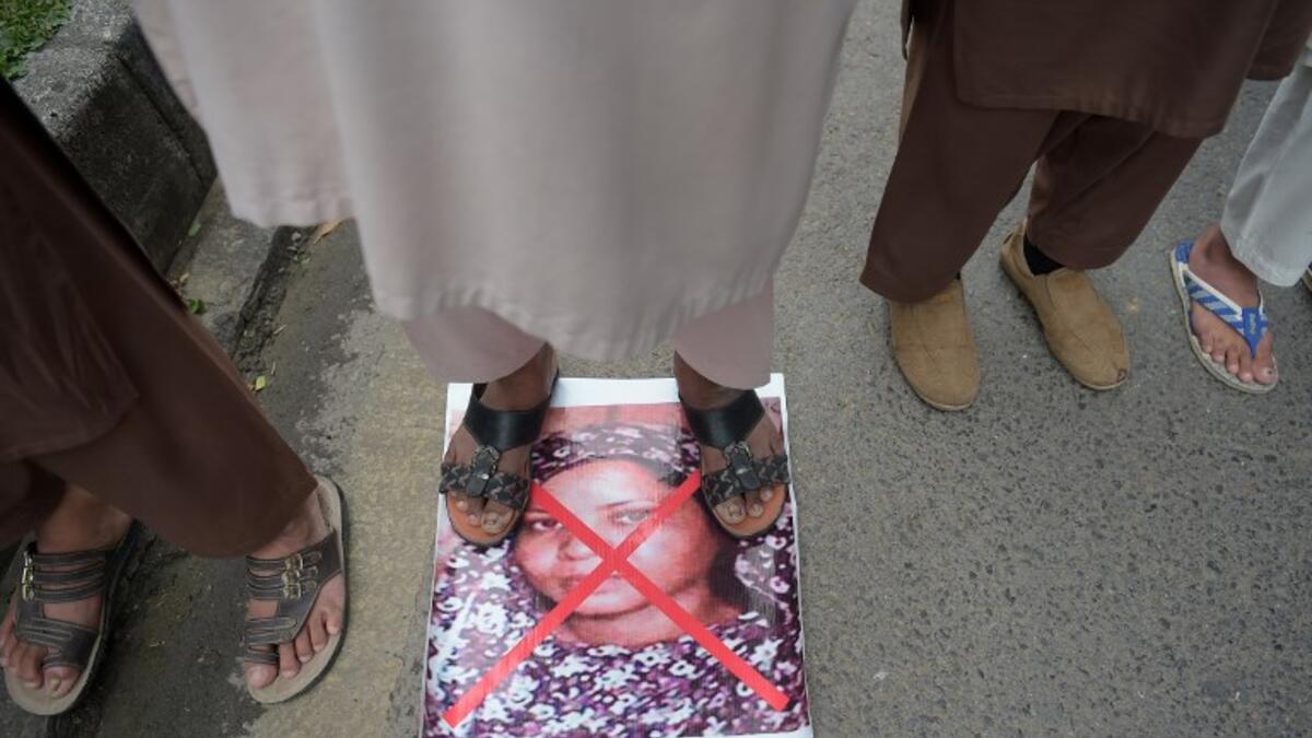 A Pakistani supporter of the Ahle Sunnat Wal Jamaat (ASWJ) stands over an image of Christian woman Asia Bibi. (AAMIR QURESHI / AFP)
