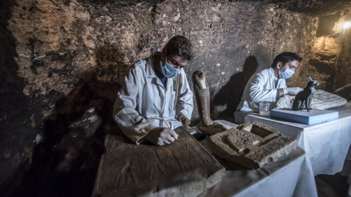 Egyptian archaeologists work on monuments after being discovered on the stony edge of King Userkaf pyramid complex in Saqqara Necropolis, south of the capital Cairo. (KHALED DESOUKI / AFP)