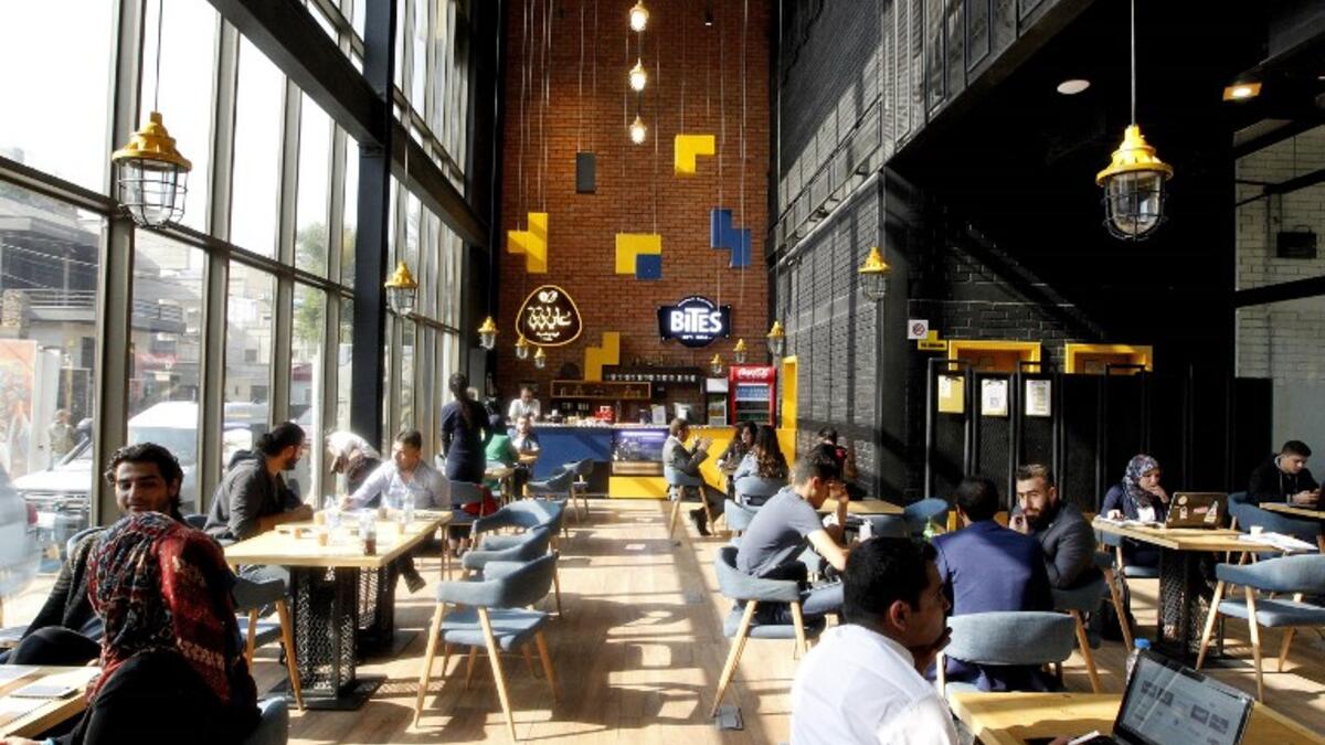 Iraqis sit at "The Station", Baghdad's incubator for would-be entrepreneurs, in the Iraqi capital on November 17, 2018. 
SABAH ARAR / AFP