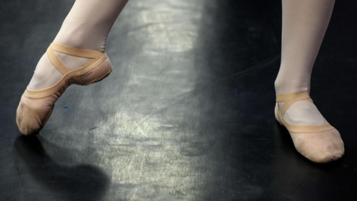 A girl attends a class at a ballet studio in Moscow on November 22, 2018. In a small studio in northern Moscow, parents and grandparents sit in a corridor waiting for children as young as three to finish their ballet class. 
Mladen ANTONOV / AFP