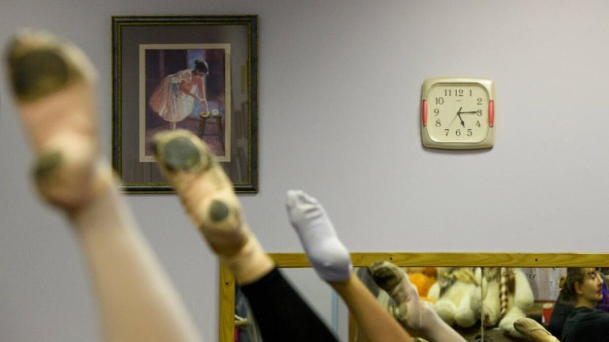 Girls attend a class at a ballet studio in Moscow on November 22, 2018. In a small studio in northern Moscow, parents and grandparents sit in a corridor waiting for children as young as three to finish their ballet class. 
Mladen ANTONOV / AFP