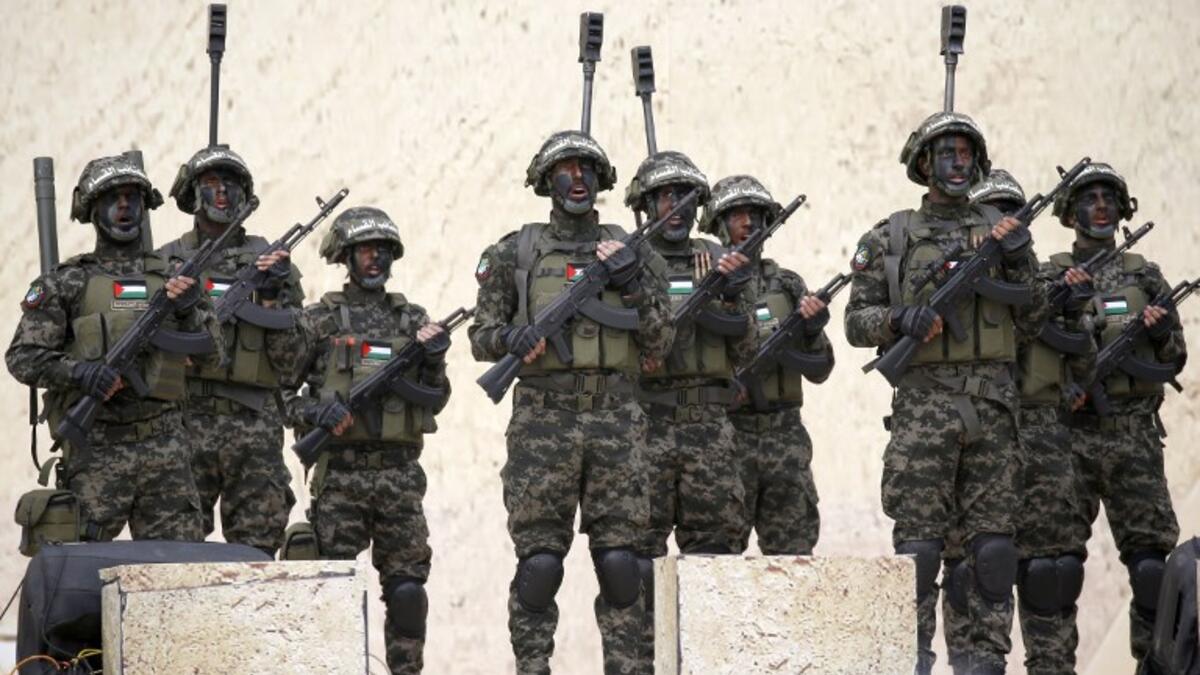 Palestinian members of al-Qassam Brigades, the armed wing of the Hamas movement, attend a rally marking the 31st anniversary of Hamas' founding, in Gaza City December 16, 2018. 
SAID KHATIB / AFP