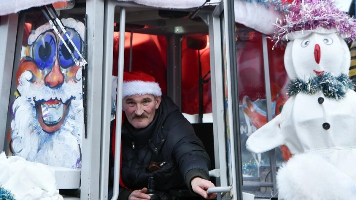 A tractor driver takes part in the New Year's car parade in the town of Vileyka about 100 km northwest from Minsk on December 29, 2018. 
Sergei GAPON / AFP