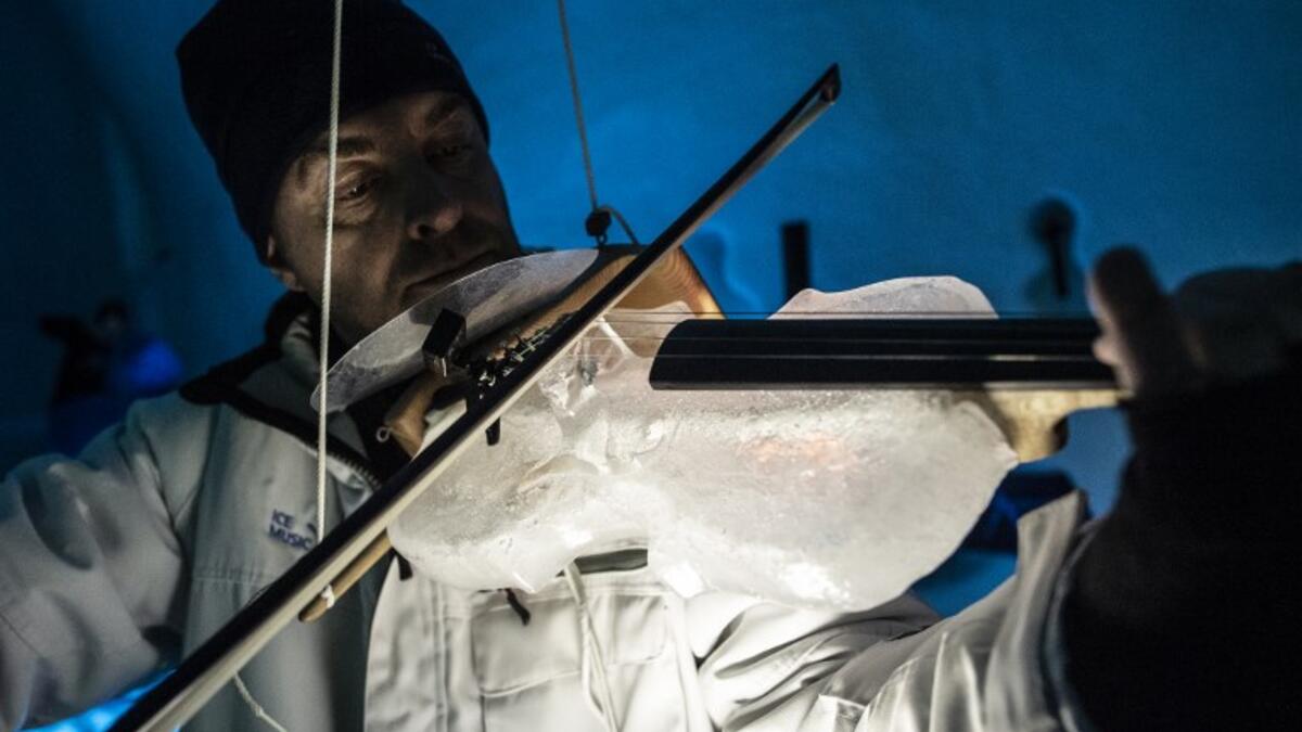 A musician performs with an ice double bass during a concert in the "Ice Dome" on Presena Galcier, Tonale Pass, near Trento in northern Italy on January 17, 2018.
MARCO BERTORELLO / AFP