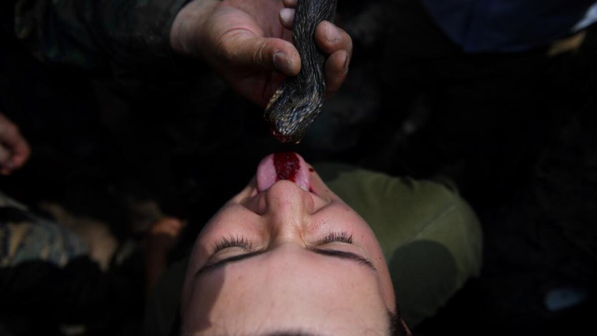 A US Marine drinks snake blood during a jungle survival training with Thai soldiers in the joint 'Cobra Gold' military exercise in Chantaburi province 
Lillian SUWANRUMPHA / AFP