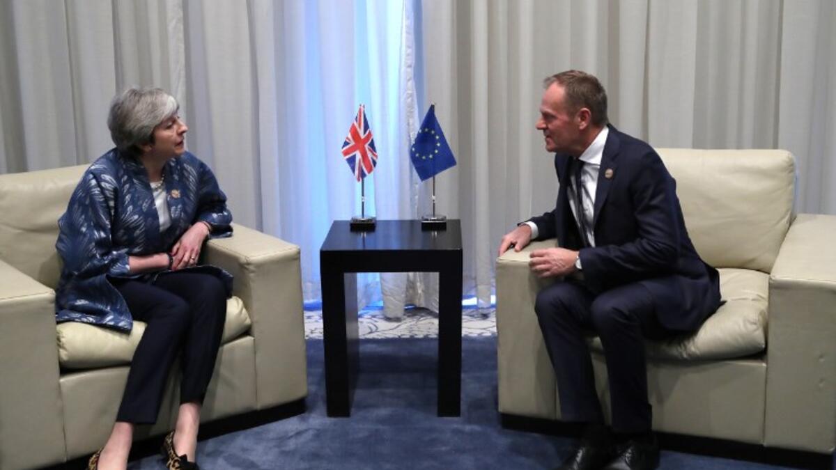 President of the European Council Donald Tusk speaks with British Prime Minister Theresa May during a bilateral meeting on February 24, 2019, on the sidelines of the first joint European Union and Arab League summit in the Egyptian Red Sea resort of Sharm el-Sheikh. 
Francisco Seco / POOL / AFP