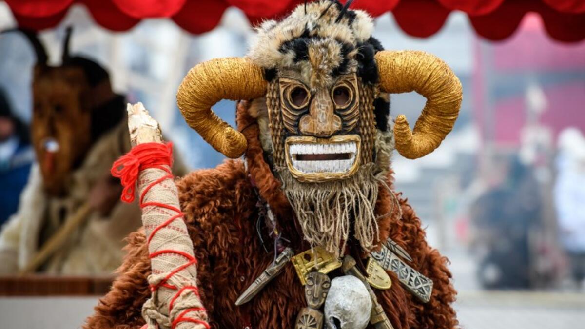 A performer in a scary mask entertains the public during the Shrovetide spring festival outside the Kremlin in Moscow on March 01, 2019. Mladen ANTONOV / AFP