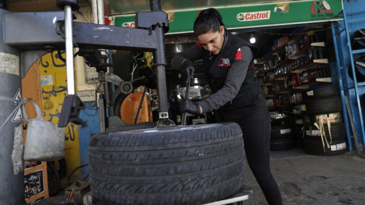 Amina repairs a flat tyre at a car tyre's repair shop in Beirut on March 8, 2019. Amina has been working for 10 years in mechanics, specially in the tyres repair business. She considers it fulfilling as she always dreamt of doing that job.
JOSEPH EID / AFP