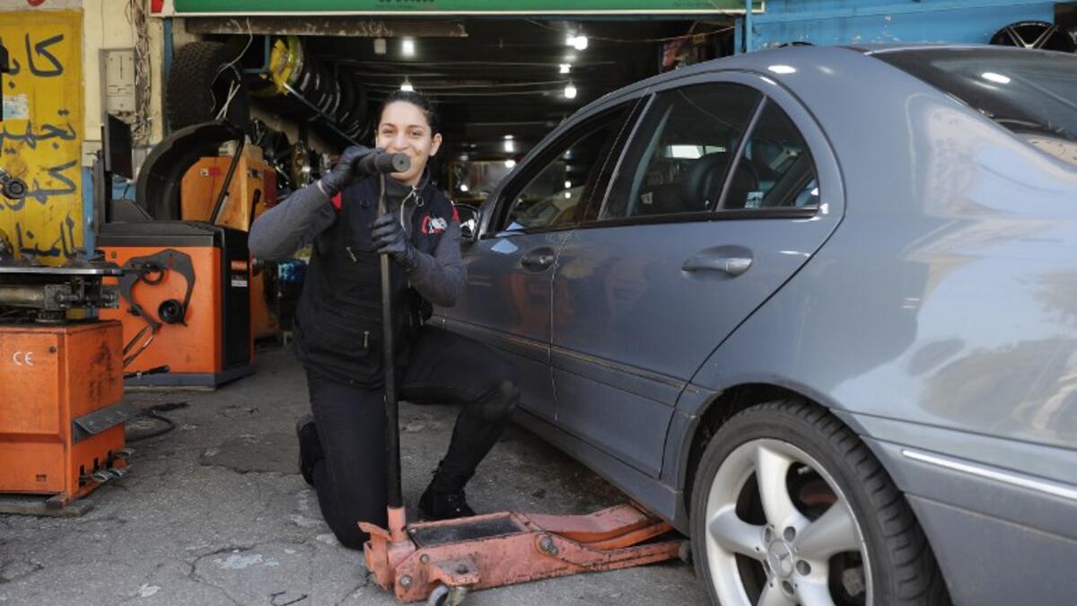 Amina repairs a flat tyre at a car tyre's repairshop in Beirut on March 8, 2019. Amina has been working for ten years in mechanics, specially in the tyres repair business. She considers it a fulfilement as she always dreamt of doing that job.
JOSEPH EID / AFP