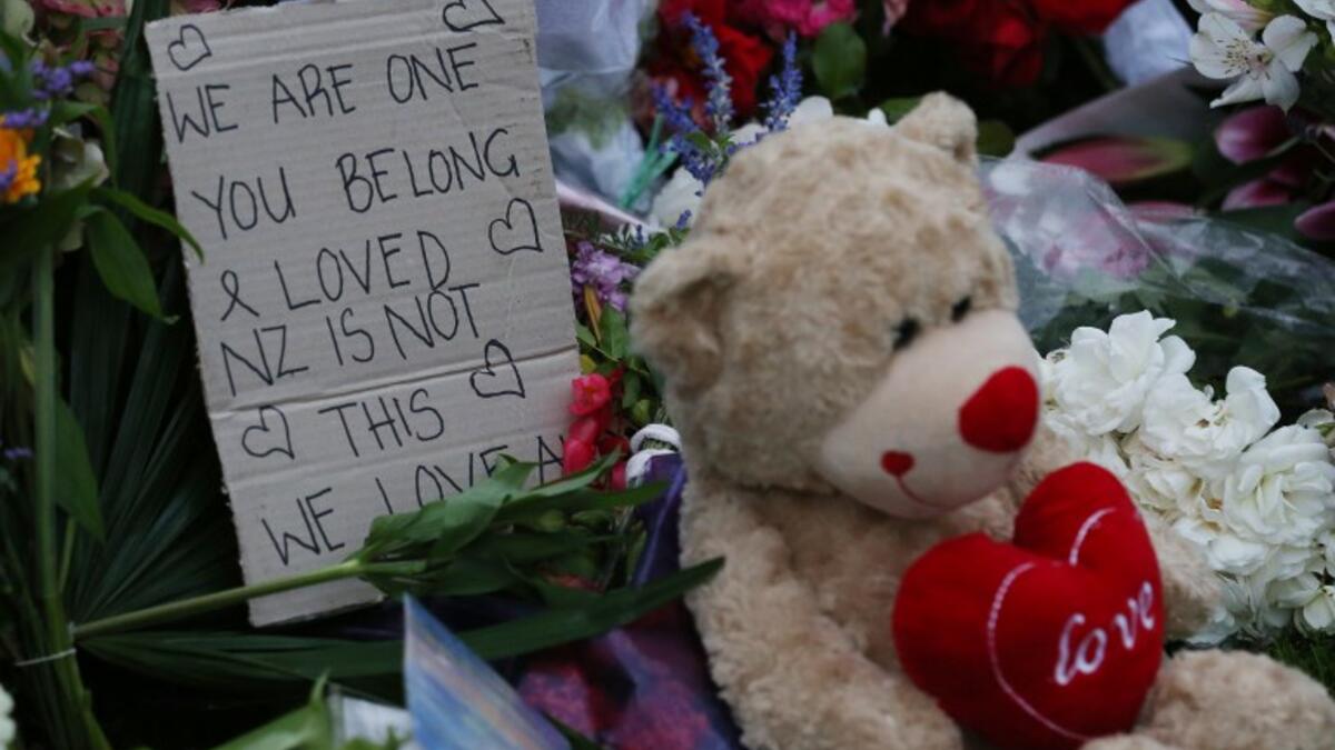 A note is seen beside floral tributes at a makeshift memorial for victims of the March 15 mosque attacks, in Christchurch 
DAVID MOIR / AFP