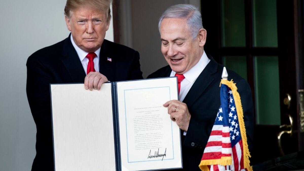 US President Donald Trump (L) and Israel's Prime Minister Benjamin Netanyahu hold up a Golan Heights proclamation outside the West Wing after a meeting in the White House March 25, 2019 in Washington, DC. 
Brendan Smialowski / AFP