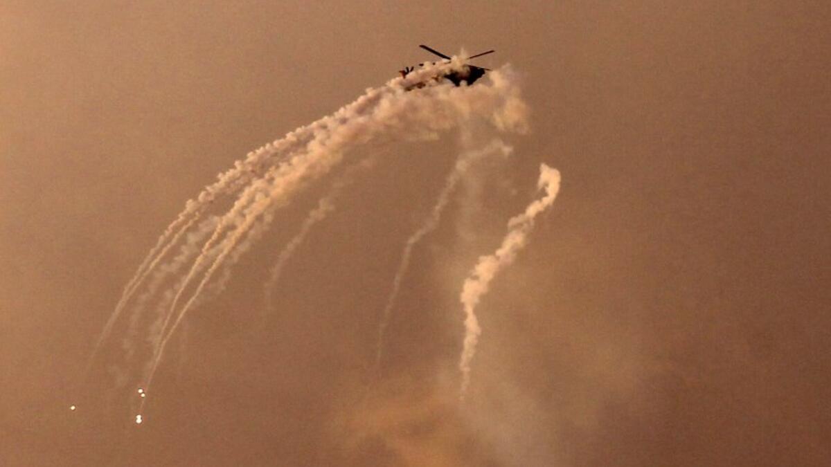 An Israeli helicopter shoots flares over the Gaza Strip on March 25, 2019. Israel launched strikes on Hamas targets in Gaza today hours after a rocket from the Palestinian enclave hit a house near Tel Aviv and wounded seven people, leading to fears of a severe escalation.
MOHAMMED ABED / AFP