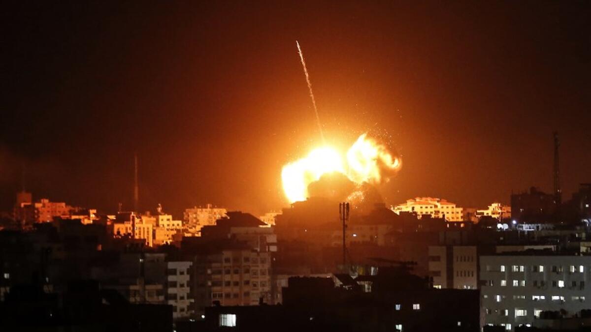 A ball of fire lights the sky above a building believed to house the offices of Hamas chief in Gaza, Ismail Haniyeh, during Israeli strikes on the Gaza City, on March 25, 2019.
Mahmud Hams / AFP