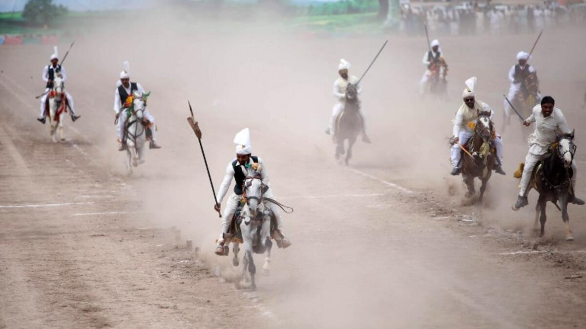 Pakistani horse riders during an attempt for a Guinness World Record for tent pegging in Khanewal district in Punjab province.
SS MIRZA / AFP