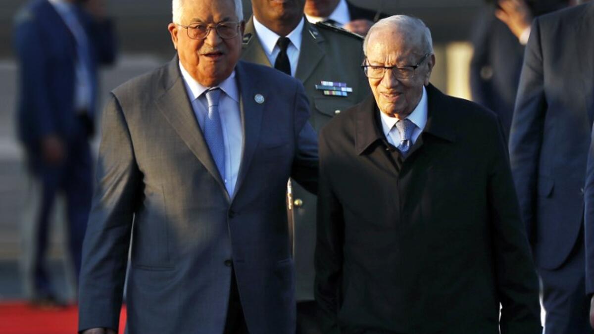 Tunisian President Beji Caid Essebsi (R) welcomes his Palestinian counterpart Mahmoud Abbas upon his arrival at Tunis-Carthage international airport on March 30, 2019, to attend the Arab Summit tomorrow. 
Hussein Malla / POOL / AFP