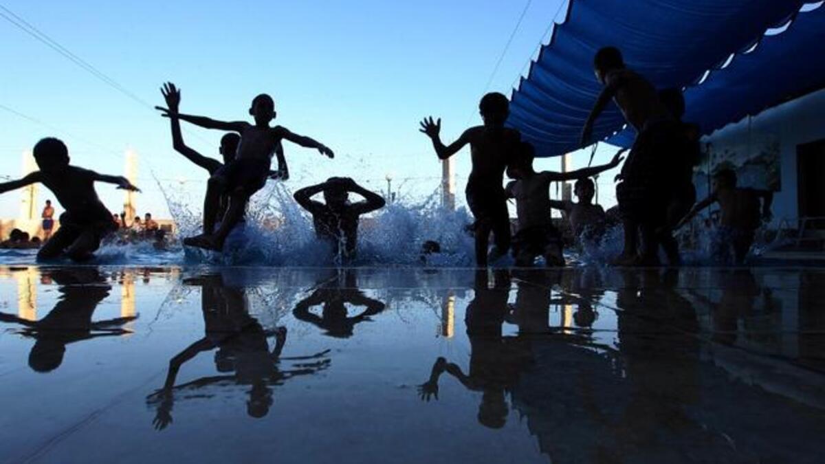 Palestinian children jump into a swimming pool in the village of Hawara, near the West Bank city of Nablus, on August 9, 2013, a day after Eid al-Fitr celebrations following the Islamic holy month of Ramadan. (AFP)
