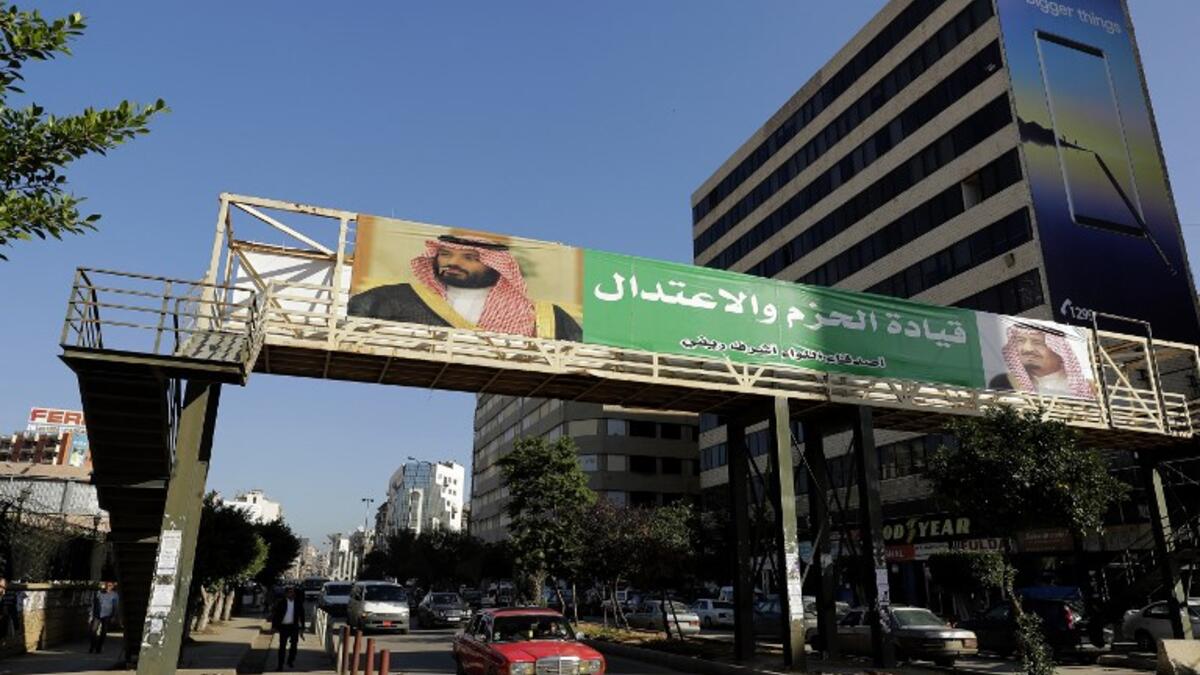 A banner bearing the images of Saudi King Salman bin Abdulaziz (R) and Crown Prince Mohammed bin Salman (L) hangs on a pedestrian crossing bridge in the northern Lebanese port city of Tripoli.

The caption in Arabic says: "firm and moderating leadership".

(JOSEPH EID / AFP)