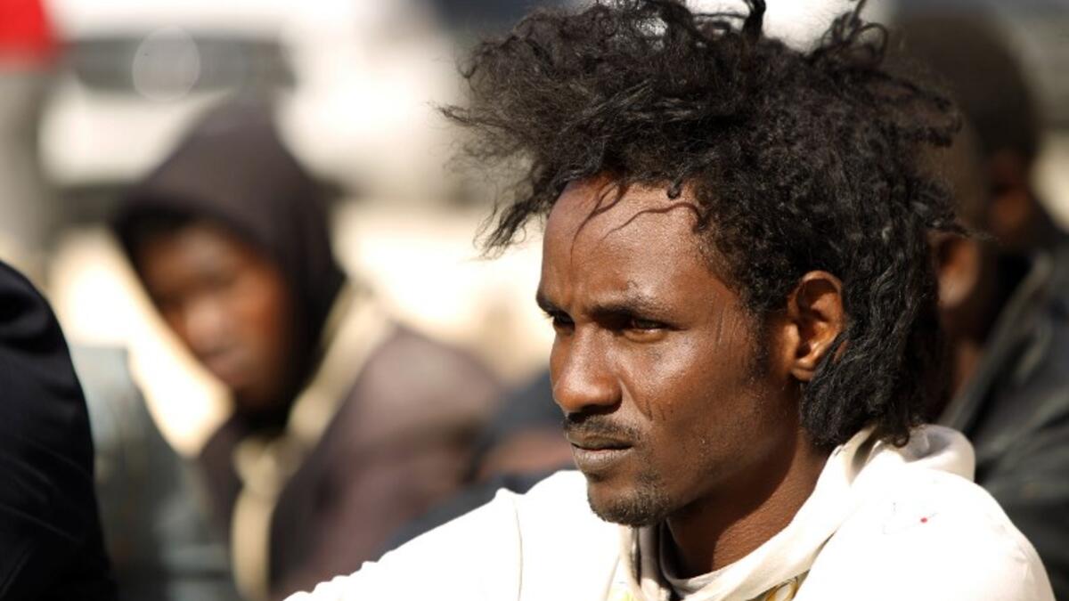 Sub-Saharan migrants sit at the Qanfouda detention centre, in the southern outskirts of Benghazi, before being repatriated, on Dec. 2, 2017. 
(Abdullah DOMA / AFP)