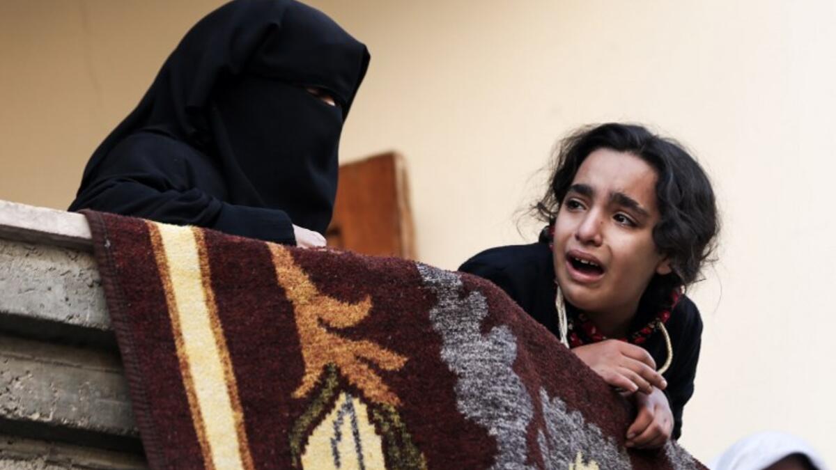 Relatives of Mohamed al-Safadi, a Palestinian militant from Hamas' Ezzedine al-Qassam Brigades who was killed the previous day in an Israeli air strike, mourn during his funeral in Gaza City. Clashes, Palestinian rocket fire and Israeli air strikes killed at least two people and wounded dozens of others on Dec. 8.
(MAHMUD HAMS / AFP)