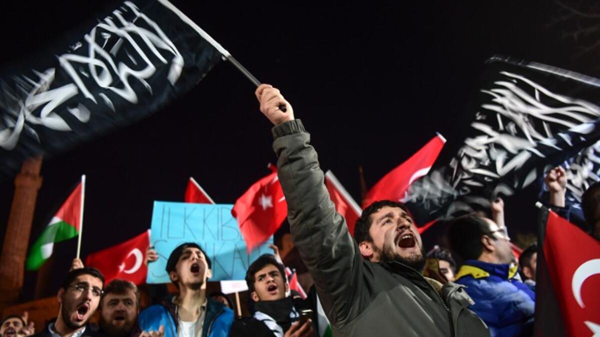 Pro-Palestine protesters chant slogans against US and Israel as they wave Turkish and Palestinian flags during a demonstration in front of Hagia Sophia museum in Istanbul. Thousands marched after prayers in Istanbul to denounce President Trump's decision to recognize Jerusalem as the capital of Israel.
(OZAN KOSE / AFP)