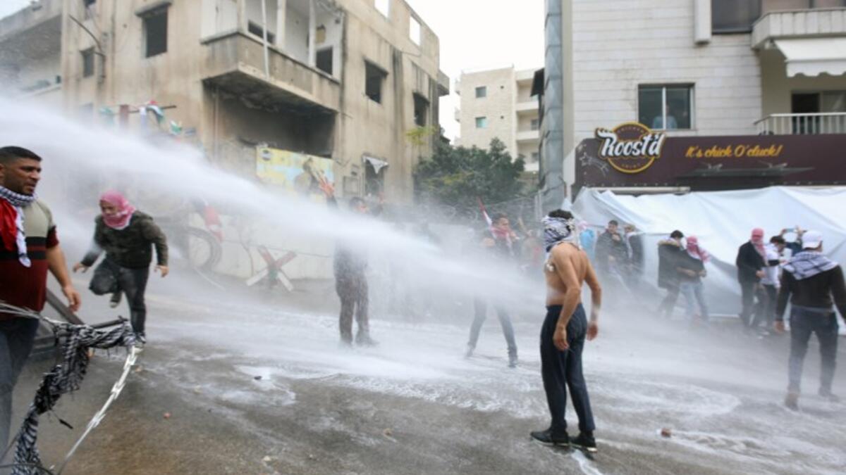 Lebanese security forces use a water hose to disperse protesters during a demonstration outside the US embassy in Awkar, on the outskirts of the Lebanese capital Beirut, on Dec. 10, 2017, to protest against Washington's decision to recognize Jerusalem as the capital of Israel. 
(ANWAR AMRO / AFP)