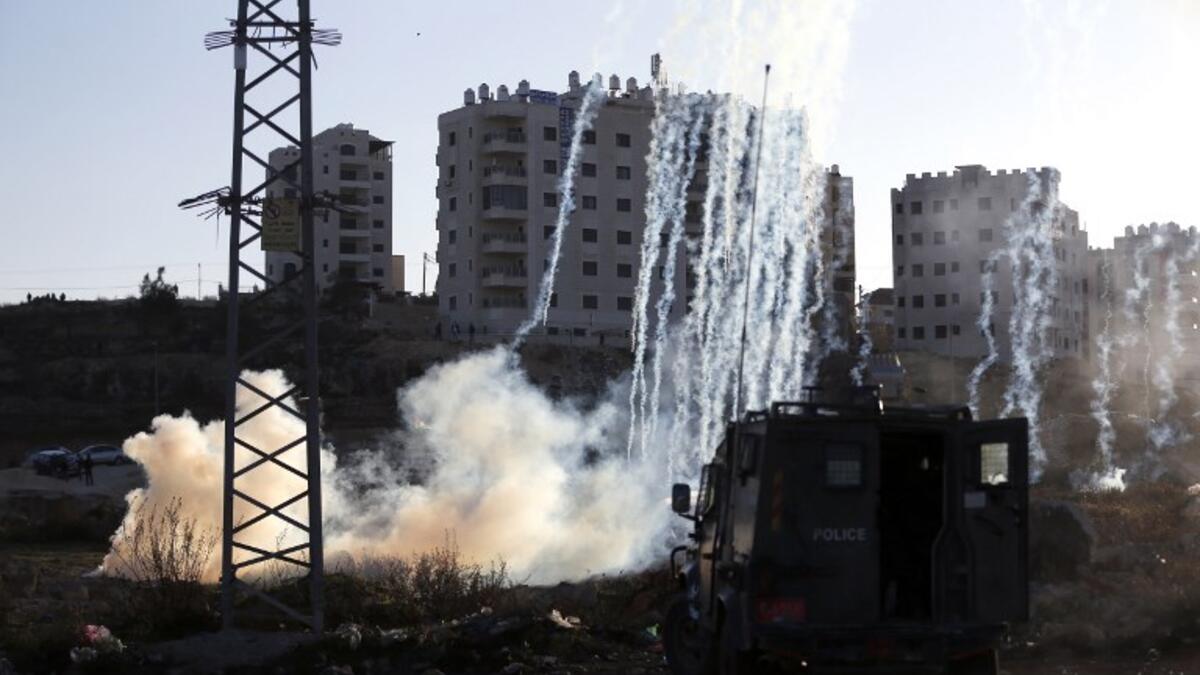 Israeli forces fire teargas at Palestinian demonstrators during clashes near an Israeli checkpoint in the West Bank city of Ramallah.
(ABBAS MOMANI / AFP)