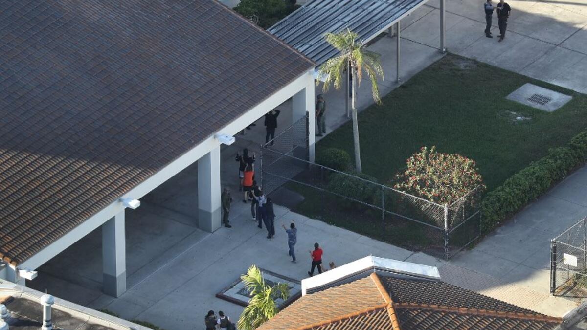 People are brought out of the Marjory Stoneman Douglas High School after a shooting at the school that reportedly killed and injured multiple people on Feb. 14, 2018 in Parkland, Florida. Numerous law enforcement officials continue to investigate the scene. 
(Joe Raedle/Getty Images/AFP)