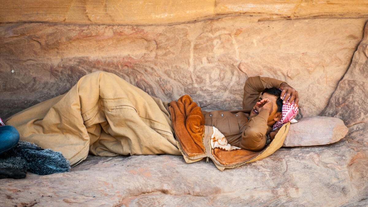 Bedouin sleeps near the rock in the desert of Wadi Rum. Bedouins are a part of a desert-dwelling Arabian ethnic group (Shutterstock/File Photo)