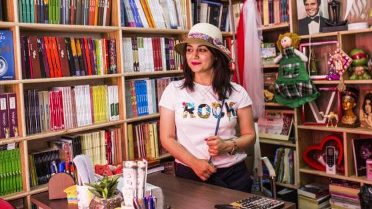 On Baghdad's famous al-Mutanabbi Street, bookstore owner Bara'a al-Bayati welcomes her customers with a smile (Twitter)