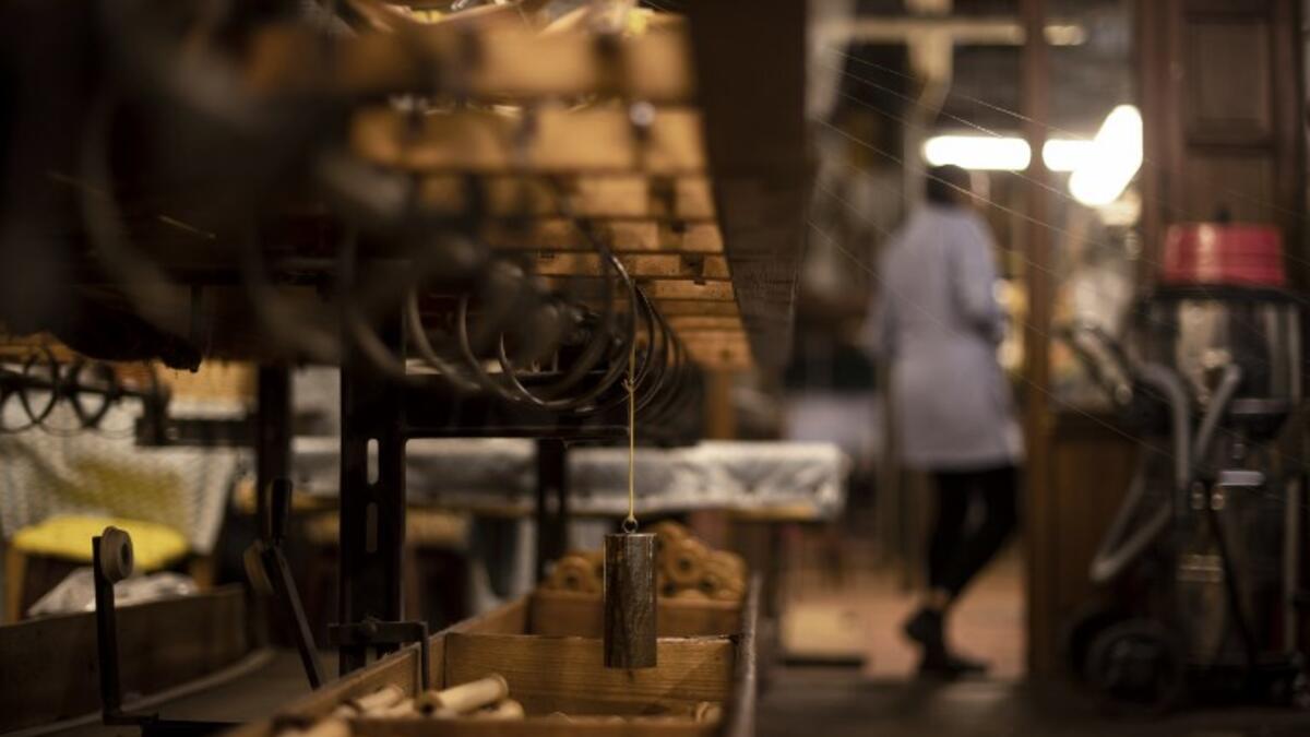 This picture shows a woman at work in the laboratory of Antico setificio Fiorentino ancient silk factory in Florence. 
Tiziana FABI / AFP