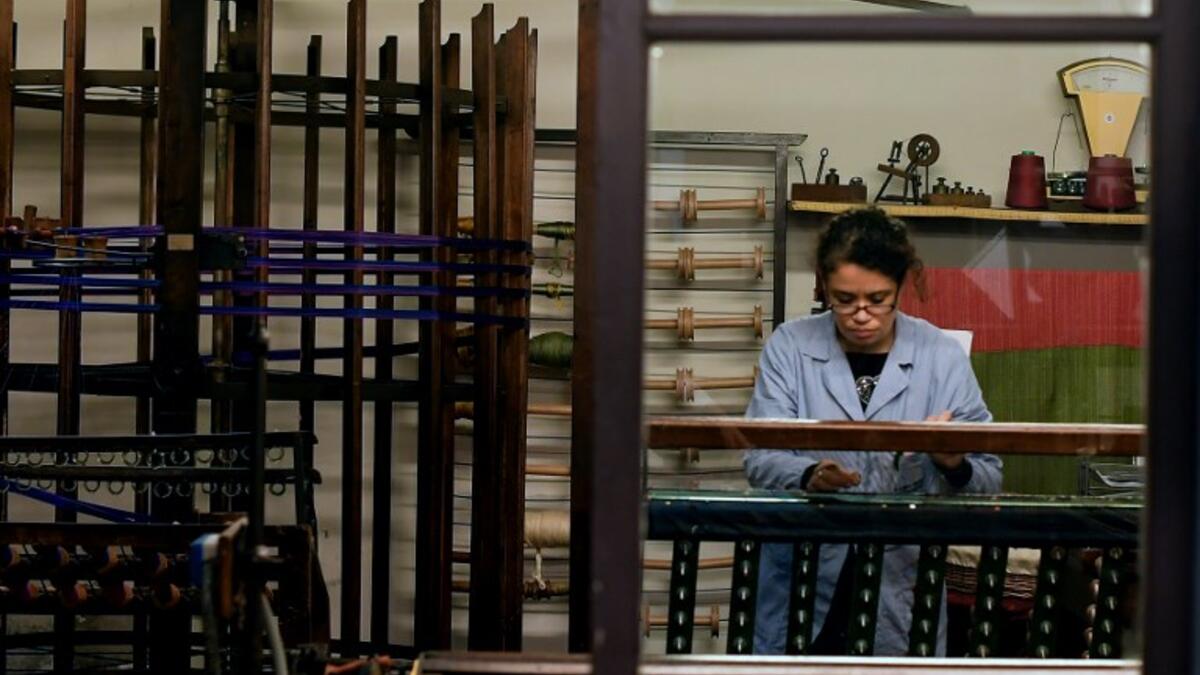 This picture shows a woman at work in the laboratory of Antico setificio Fiorentino ancient silk factory in Florence. 
Tiziana FABI / AFP