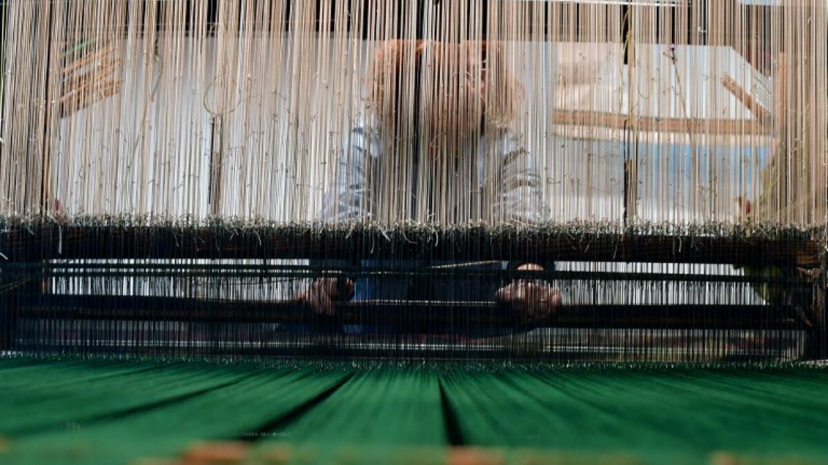 This picture shows a woman at work in the laboratory of Antico setificio Fiorentino ancient silk factory in Florence. 
Tiziana FABI / AFP