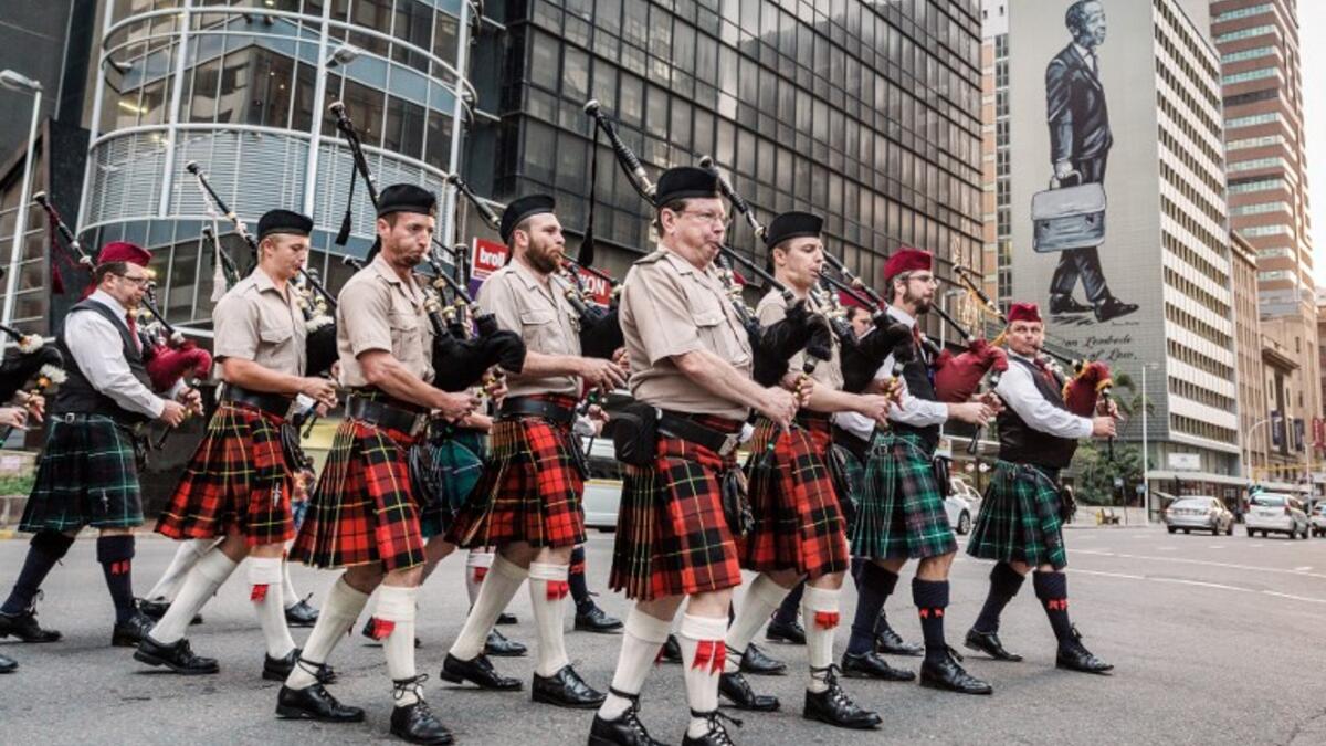 Pipers part of a military orchestra take part in a Sunset Parade in Durban, on November 11, 2018 as part of commemorations marking the 100th anniversary of the 11 November 1918 armistice, ending World War I. 
RAJESH JANTILAL / AFP