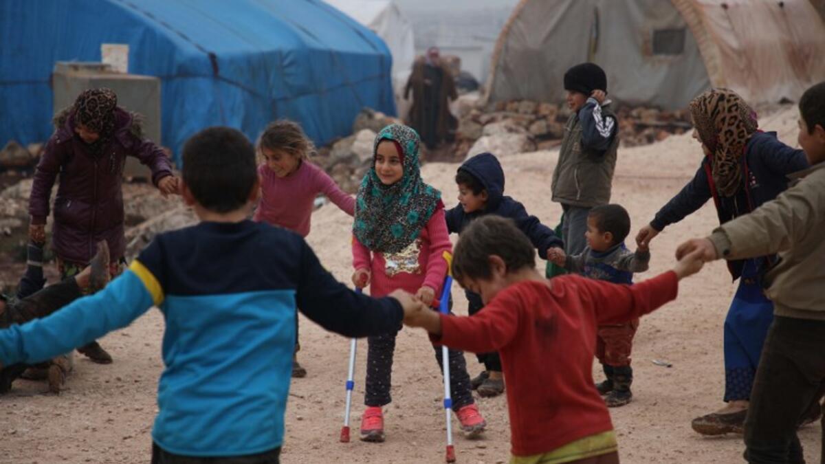 Maya Merhi (C) plays with her friends in the Internally Displaced Persons (IDP) camp of Serjilla in northwestern Syria next to Bab al-Hawa border crossing with Turkey
Aaref WATAD / AFP
