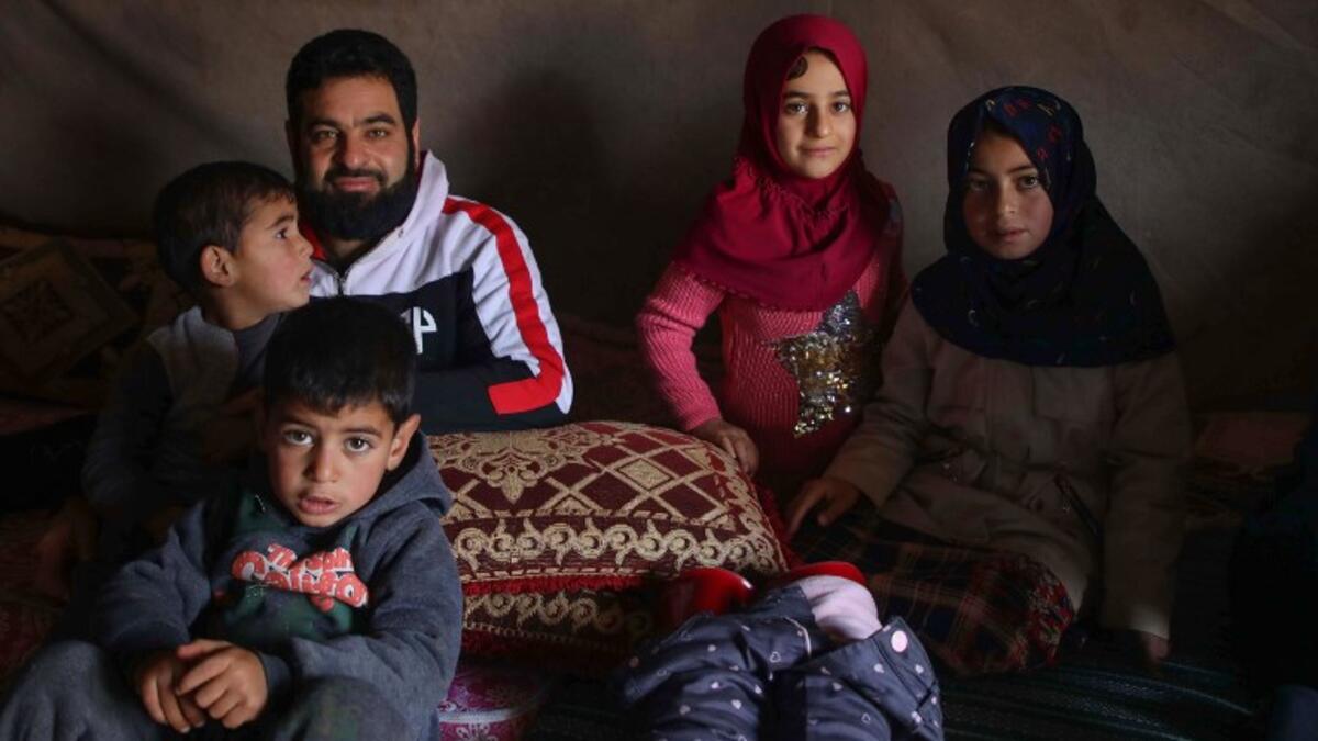 Maya Merhi (2nd R) sits with her family inside their tent at the Internally Displaced Persons (IDP) camp of Serjilla in northwestern Syria next to Bab al-Hawa border crossing with Turkey.
Aaref WATAD / AFP