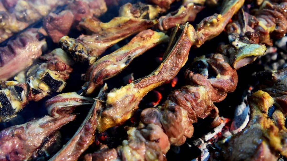 Grilled meat is cooked at the Charsi (Hashish) Tikka restaurant in Namak Mandi in Peshawar.
ABDUL MAJEED / AFP