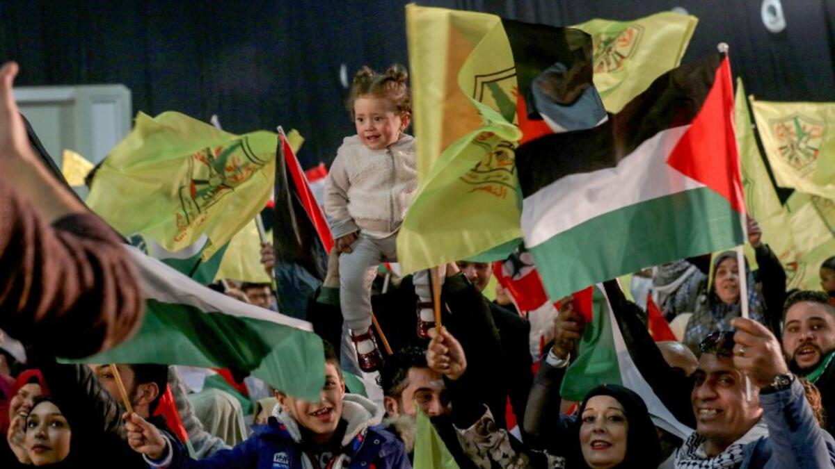 People wave flags of Palestine and Fatah as they attend a mass wedding ceremony for 150 Palestinian couples and 50 other Lebanese couples
Mahmoud ZAYYAT / AFP