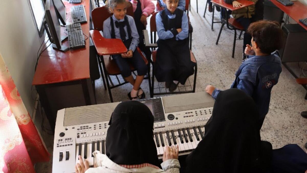 Children attend a music class at the Al-Nawras school in Taez, Yemen's third city, in the country's southwest
AHMAD AL-BASHA / AFP