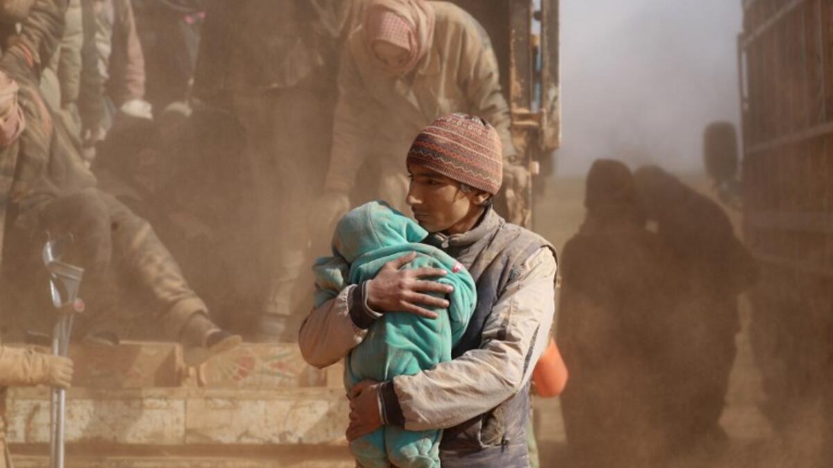 People who fled battles between Syrian Democratic Forces (SDF) and ISIS fighters in the Syrian village of Baghouz, arrive after crossing a desert in the back of a truck to a region controlled by the SFD in the countryside of the Deir Ezzor province. Delil SOULEIMAN / AFP