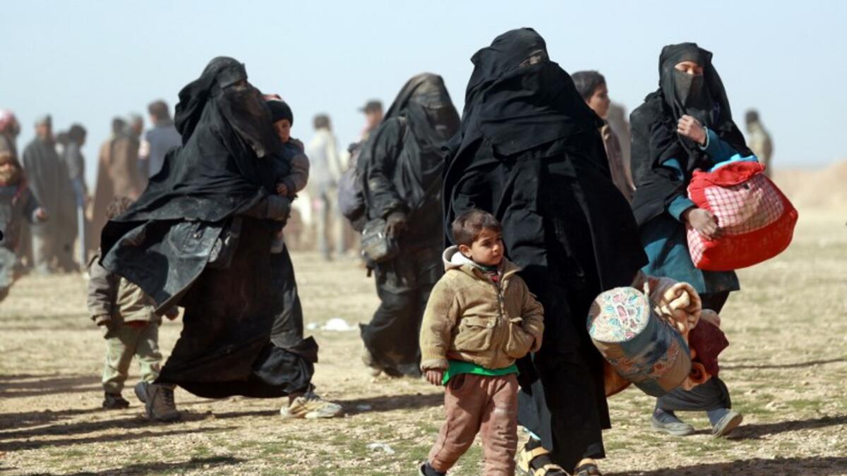 People who fled battles between Syrian Democratic Forces (SDF) and ISIS fighters in the Syrian village of Baghouz, arrive after crossing a desert in the back of a truck to a region controlled by the SFD in the countryside of the Deir Ezzor province. Delil SOULEIMAN / AFP