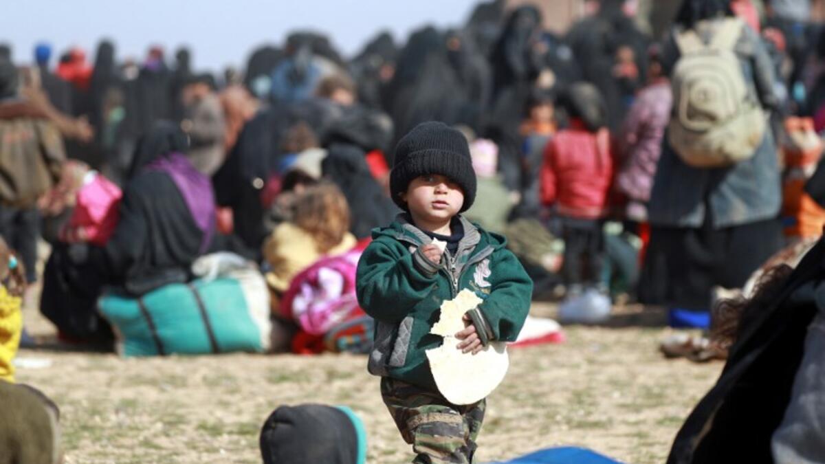 People who fled battles between Syrian Democratic Forces (SDF) and ISIS fighters in the Syrian village of Baghouz, arrive after crossing a desert in the back of a truck to a region controlled by the SFD in the countryside of the Deir Ezzor province. Delil SOULEIMAN / AFP