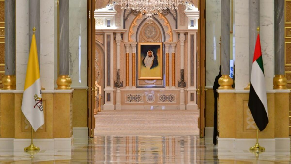 The national flags of Vatican (L) and United Arab Emirates are pictured at the presidential palace in the capital Abu Dhabi during a reception for Pope Francis, on February 4, 2019. 
Giuseppe CACACE / AFP