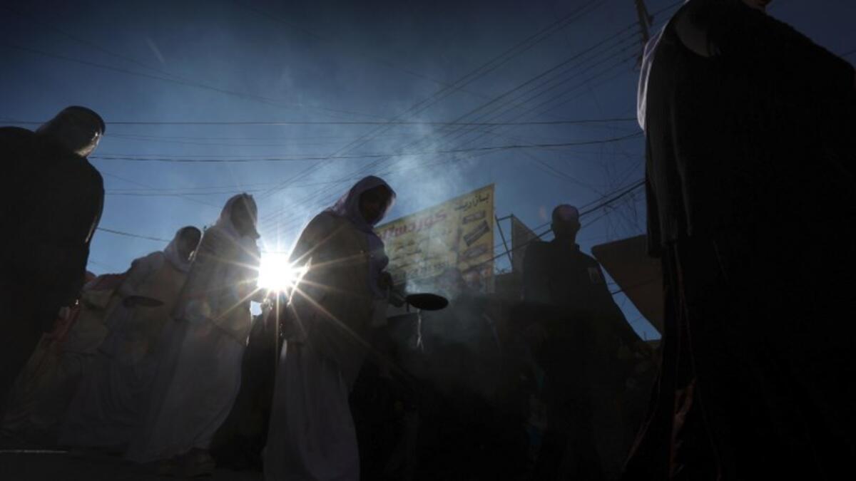 Iraqi Yazidis attend the funeral of the Mir Takhsin-Beg (Tahseen Said Ali), the hereditary leader of the Yazidi community in the world, in the town of Sheikhan, 50km northeast of Mosul.
SAFIN HAMED / AFP