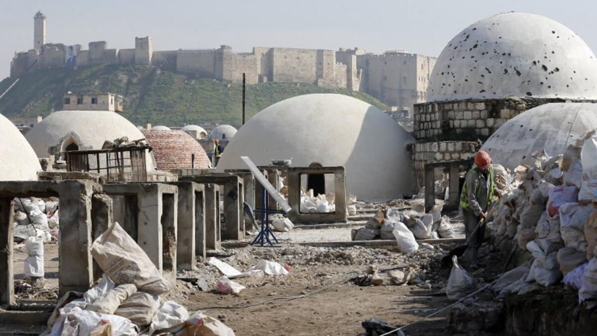 Labourers take part in restoration work at the Saqatiya market in the old quarter of Syria's second city of Aleppo 
LOUAI BESHARA / AFP