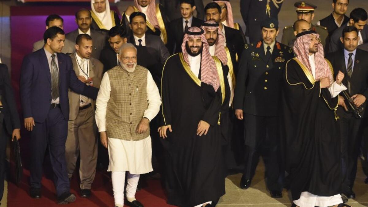 Saudi Crown Prince Mohammed Bin Salman (centre R) walks next to Indian Prime Minister Narendra Modi upon arriving at the airport in New Delhi 
Money SHARMA / AFP