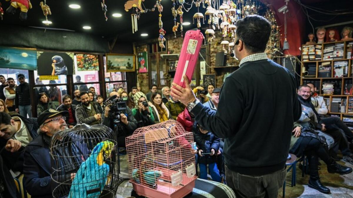 An auctioneer shows items to the audience at an auction house in Istanbul's Balat district.
OZAN KOSE / AFP