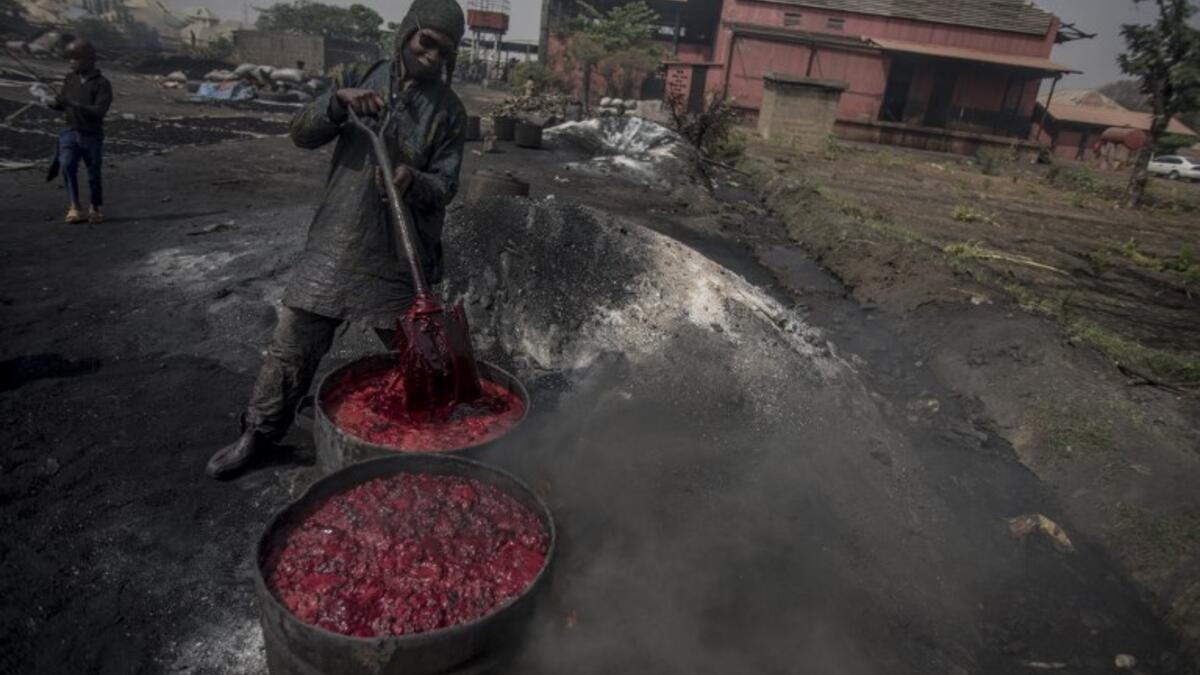 A young man boils cow blood before the sun-drying process to make fertiliser at Kaduna Abatour meat market in North Kaduna CRISTINA ALDEHUELA / AFP