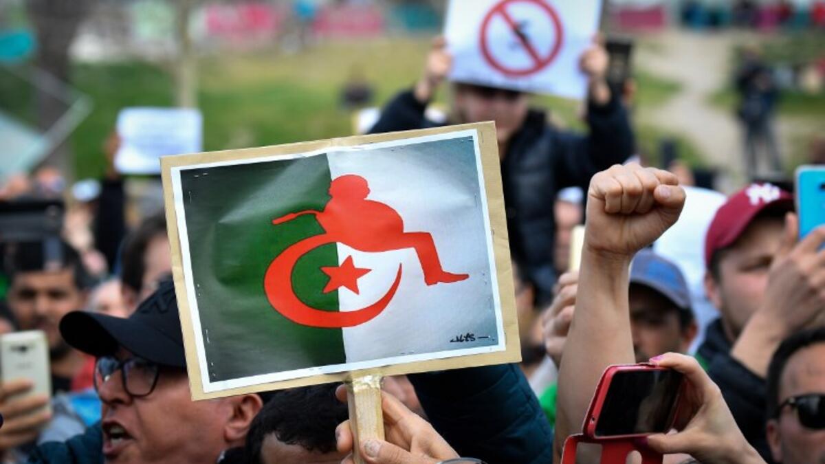 Protesters hold placards during a sit-in against the Algerian presidential bid for a fifth term in office
GERARD JULIEN / AFP