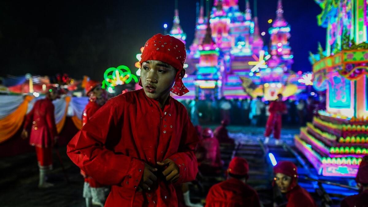 Traditional dancers wait to perform during abbot Kay Lar Tha's funeral procession in Mudon, Mon State. 
Ye Aung THU / AFP