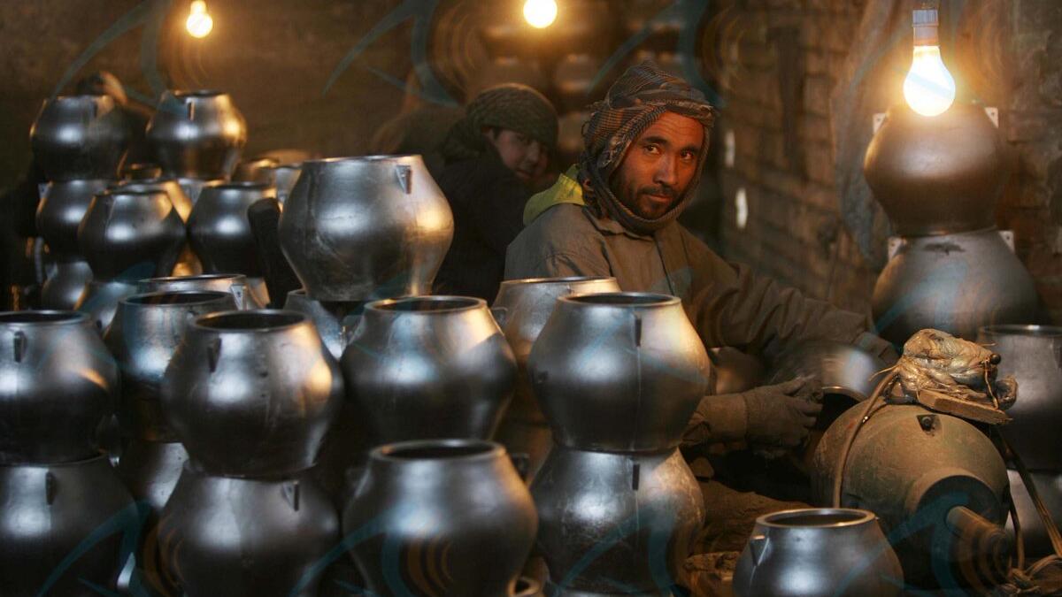 In this photo an Afghan labourer makes metal pots at an aluminum factory in Herat. 
HOSHANG HASHIMI / AFP